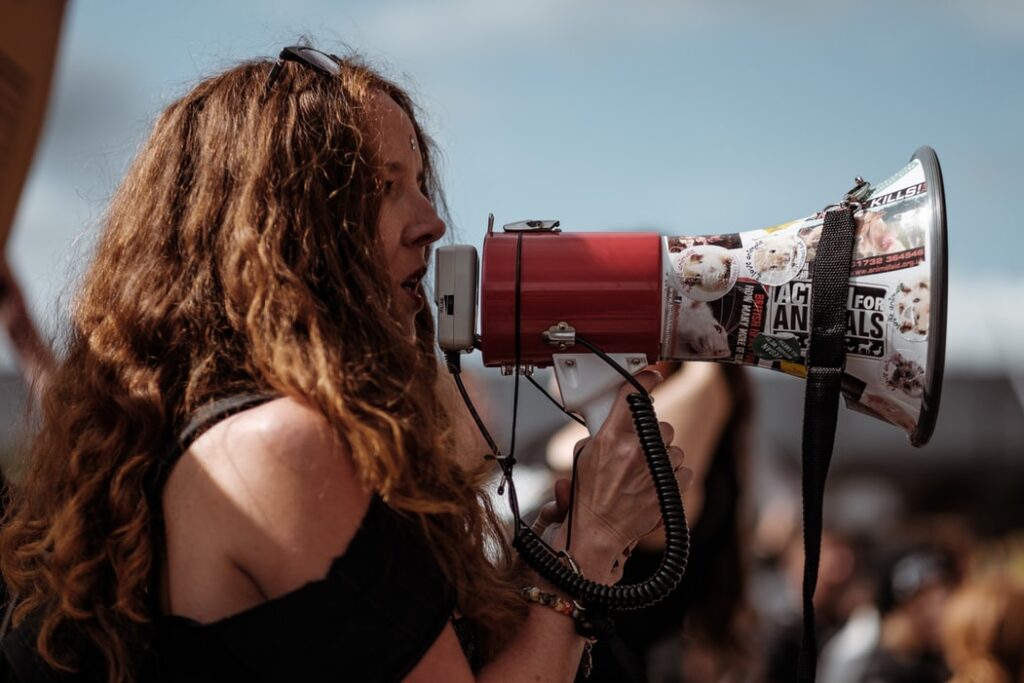 Woman with a loud speaker to symbolise how to reach out after losing touch
